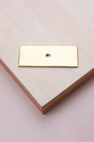 Polished brass rectangle backplate, 60 x 25mm: solid brass with a 4mm centre hole for the knob bolt