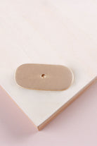 Satin brass oblong backplate, 54 x 25mm with rounded ends: solid brass with a 4mm centre hole for the knob bolt