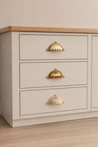 Scalloped cup pull in polished, aged and satin brass