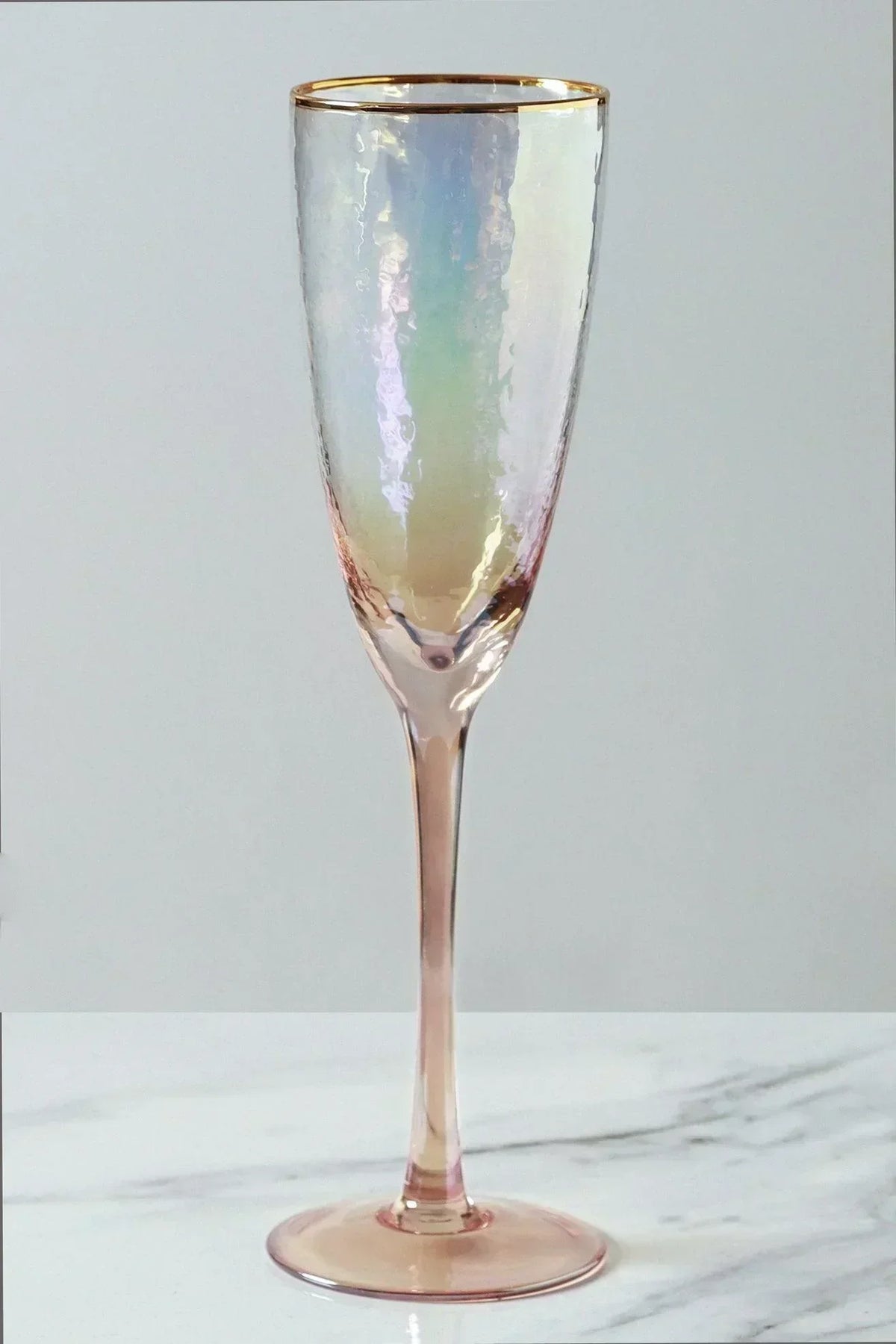 Set of four iridescent pearl hammered champagne flutes styled together — G Decor