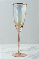 Set of four iridescent pearl hammered champagne flutes styled together — G Decor