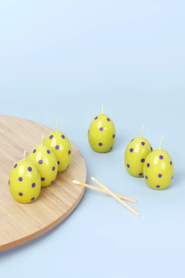 Grüne Oster-Polka-Ei-Kerzen auf einer Frühlingswiese