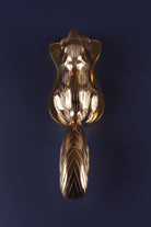 Brass squirrel door knocker from the front, showing its bushy tail