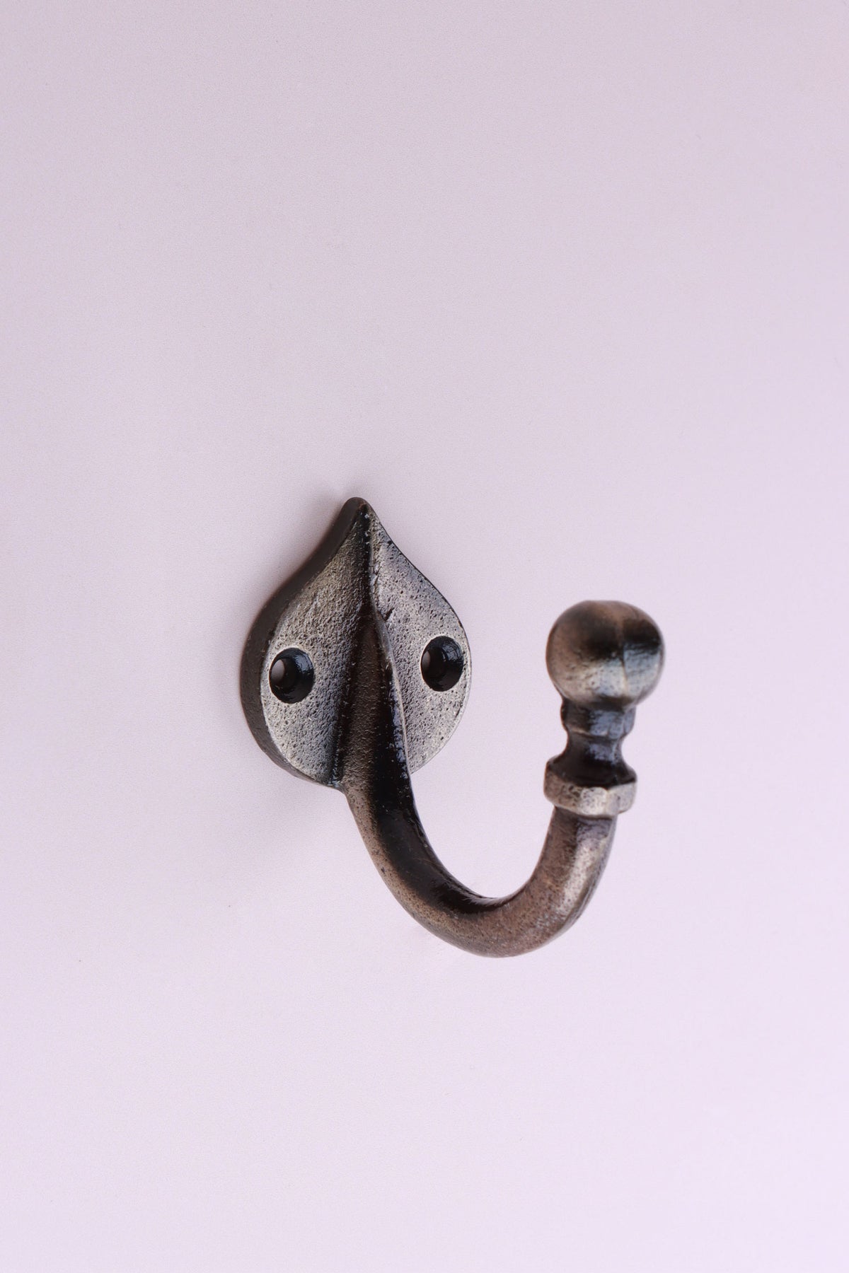 Teardrop Hook: cast iron single hook with a ball end, on a pointed teardrop back plate, antique brass finish