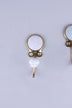 White crackle glaze ceramic coat hook: white disc with fine grey crackle lines in a gold-tone frame, with a white crackle knob
