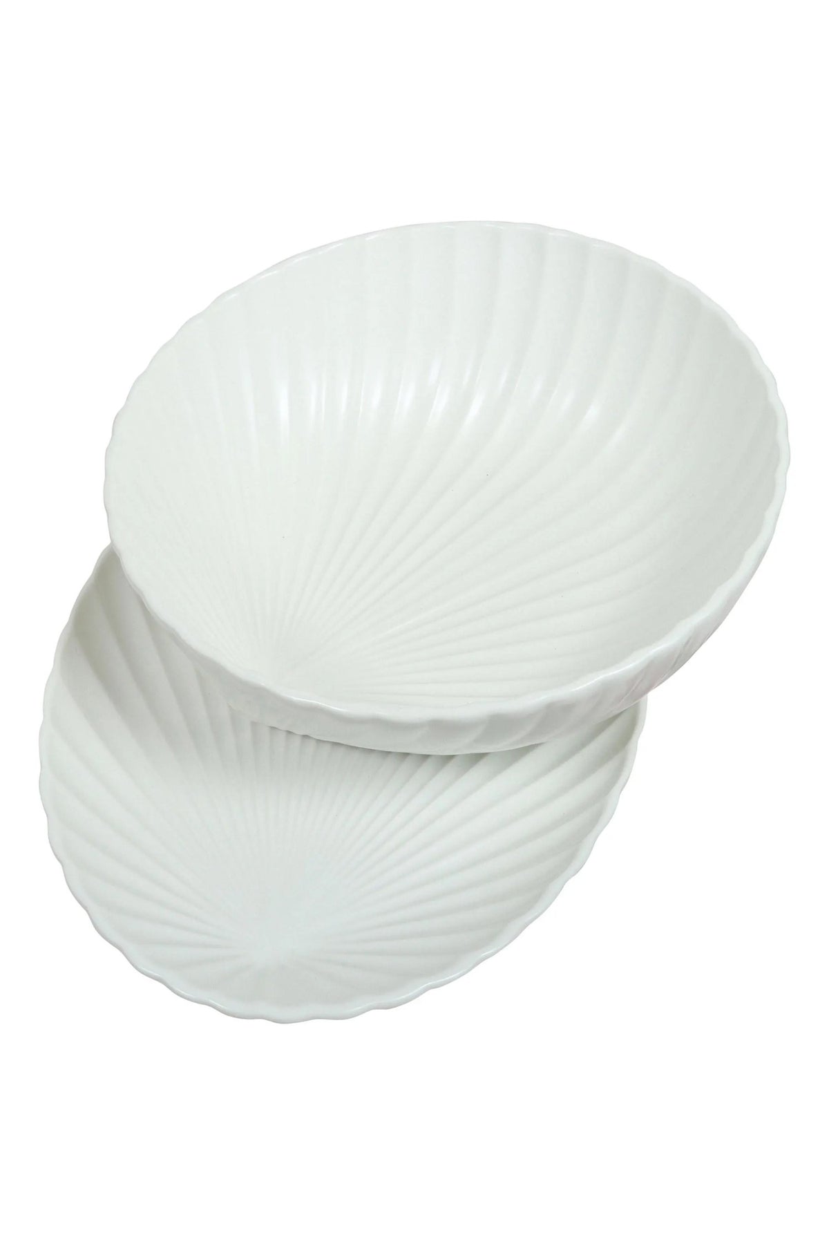 The shell bowl resting on the oval shell dish, on a white background