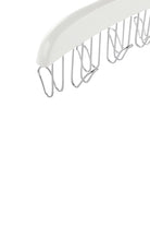 Close-up of the metal hooks under the white wooden belt hanger