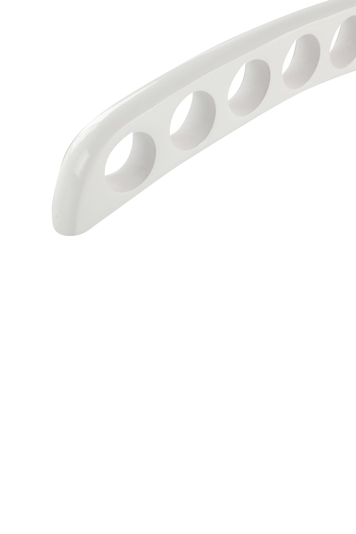 Close-up of the round holes in the white wooden scarf hanger