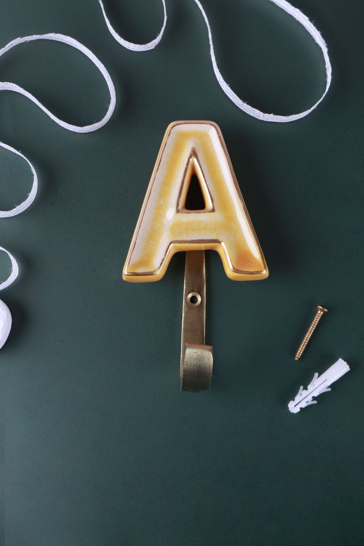 Yellow ceramic letter hook A with a gold rim