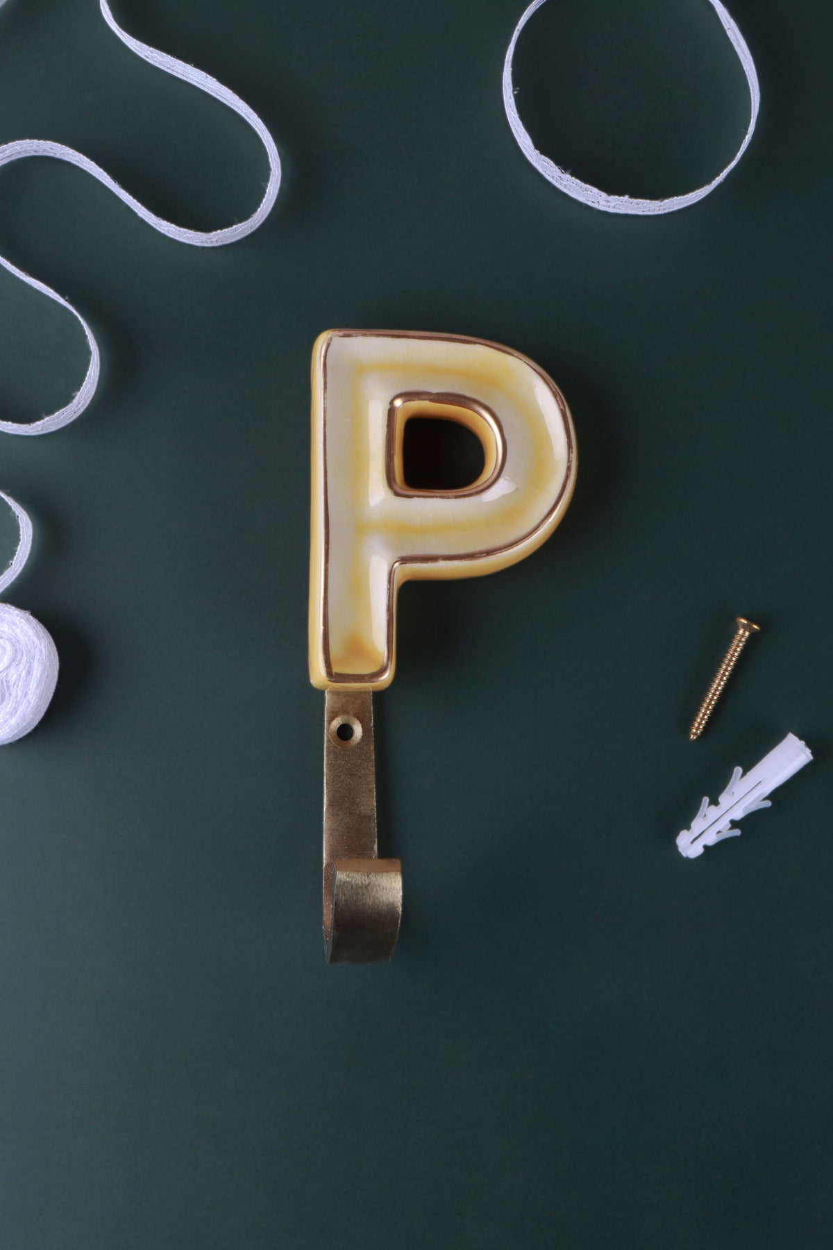 Yellow ceramic letter hook P with a gold rim