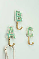 Personalised green crackle monogram coat hook with antique brass letter — hand-painted ceramic, G Decor